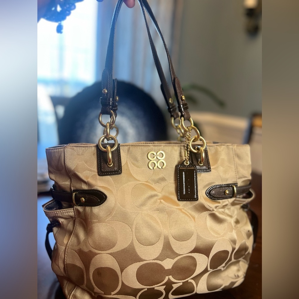 Coach purse with the gold metal hardware and brown straps